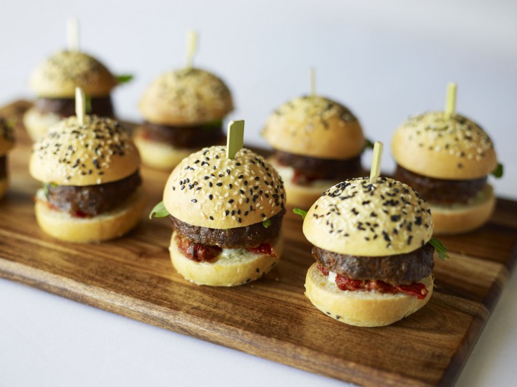 Mini burgers on a wooden board