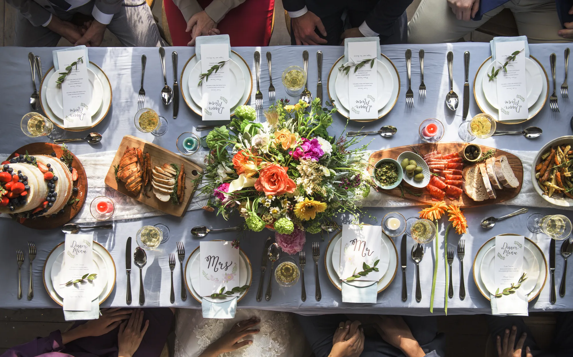 Aerial view of a set table with flowers and bespoke menu cards